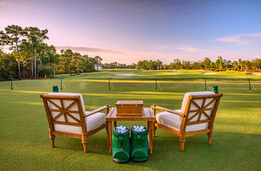 Chairs and golf balls on driving range