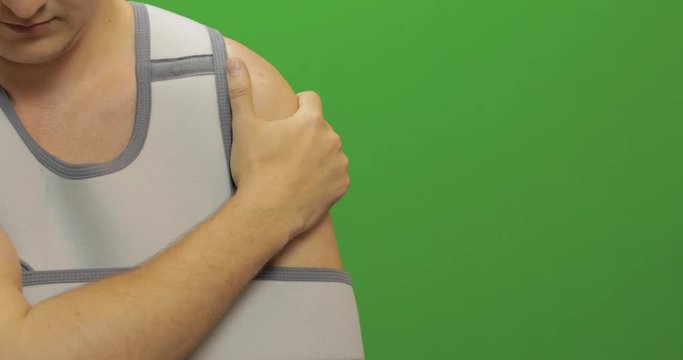 Man with shoulder injury. Nurse makes prick from pain. Bandage fixing shoulder