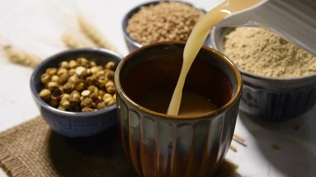 Sattu sharbat is a cooling sweet drink made in summer with roasted black chickpea flour, barley, suger, salt & water. served in a glass. selective focus