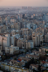 Obraz premium Aerial view of a residential neighborhood in a city during a vibrant and colorful sunrise. Taken in Netanya, Center District, Israel.