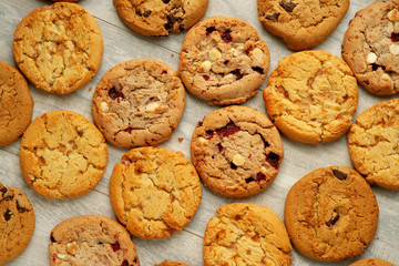 Background from oatmeal cookies. Lots of oatmeal cookies with nuts, jam and chocolate. Dry pastries in the form of oatmeal cookies for breakfast.
