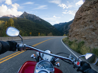 Riding on a motorcycle on a beautiful scenic road surrounded by the Canadian Mountains. Taken...