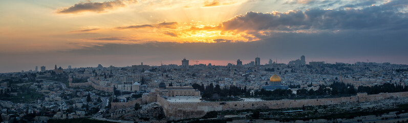 Fototapeta na wymiar Beautiful panoramic aerial view of the Old City and Dome of the Rock during a dramatic colorful sunset. Taken in Jerusalem, Capital of Israel.