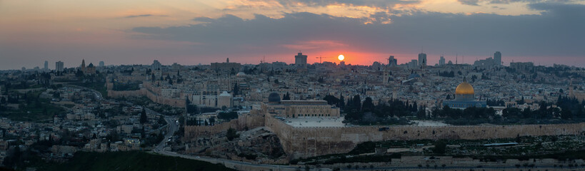 Fototapeta premium Beautiful panoramic aerial view of the Old City and Dome of the Rock during a dramatic colorful sunset. Taken in Jerusalem, Capital of Israel.