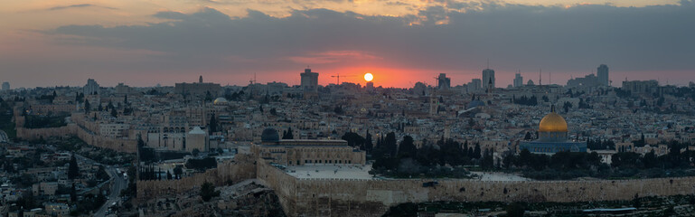 Fototapeta premium Beautiful panoramic aerial view of the Old City and Dome of the Rock during a dramatic colorful sunset. Taken in Jerusalem, Capital of Israel.