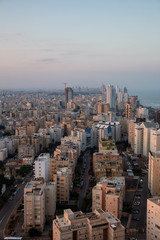 Aerial view of a residential neighborhood in a city during a vibrant and colorful sunrise. Taken in Netanya, Center District, Israel.