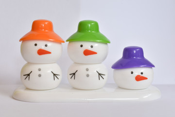 beautiful snowman with colorful caps
