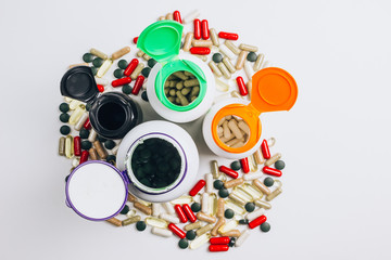 Various medications and vitamins, a pill bottle.