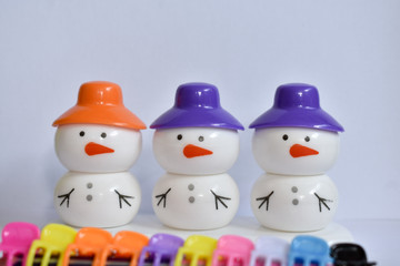 beautiful snowman with colorful caps