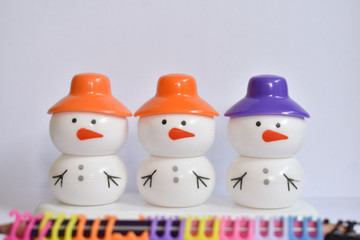 beautiful snowman with colorful caps