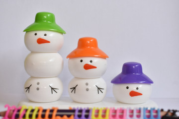 beautiful snowman with colorful caps