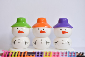beautiful snowman with colorful caps