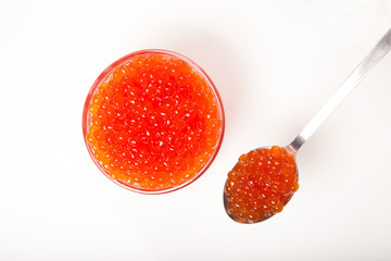 red caviar in glass bowl with spoon isolated on white background