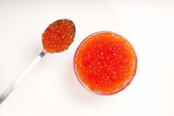 red caviar in glass bowl with spoon isolated on white background