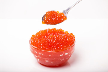 red caviar in glass bowl with spoon isolated on white background