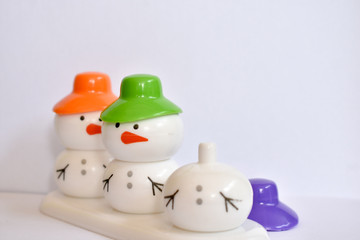 beautiful snowman with colorful caps