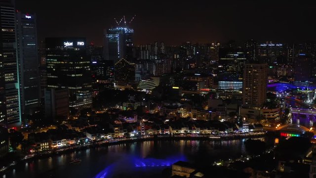 night illumination singapore city downtown riverside boat quay bay aerial panorama 4k 