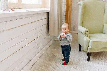 Cute little toddler boy snacking standing