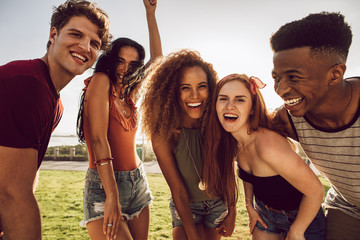 Cheerful friends dancing outdoors