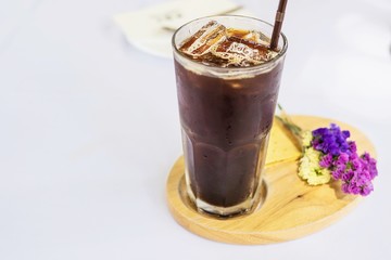 Cold americano glass on white cloth cover table - cold relax beverage concept