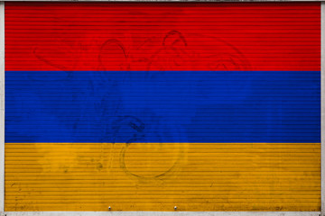 Close-up of old metal wall with national flag of Armenia. Concept of Armenia export-import, storage...