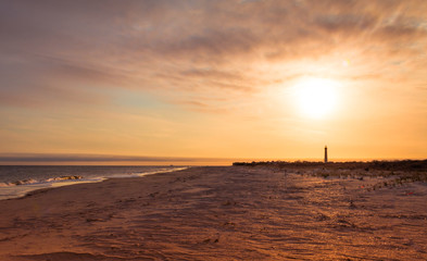 Cape May NJ lighthouse at sunset in early spring Atlantic Ocean with warm soft light