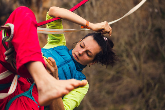 A woman tries to climb the highline.