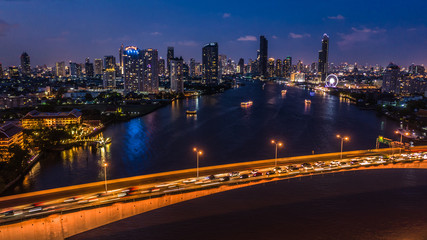 Aerial view Bangkok city skyline and skyscraper at night with business building in Bangkok downtown, Chao Phraya River, Bangkok, Thailand.