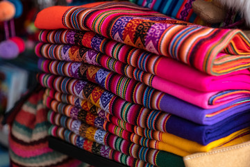 Colorful Peruvian artisanal textiles cloth with inca and traditional patterns for sale at street...