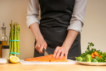 cooking chef red fish, salmon, trout. with side dish and salad. recipe book, menu, cooking tasty and wholesome food, restaurant or hotel menu