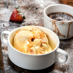 vanila ice cream in white cup with hot chocolate