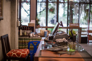 The background of a blurred counter, with a calculator, a barcode scanner, and a small tree placed on the table