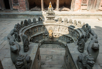 The holy carved sunken water tank (named Tusha Hiti) in royal palace of Patan Durbar square was...