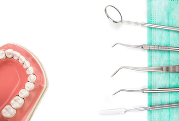 Dentist tool with mask and teeth model.