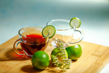 Black tea in cup with lemon