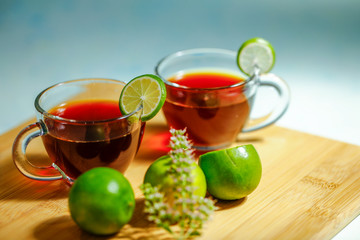 Black tea in cup with lemon
