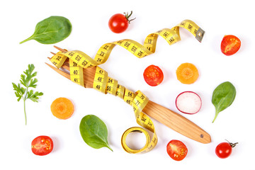 Fresh vegetables and centimeter with fork, concept of slimming and healthy nutrition