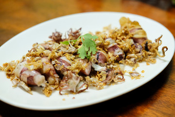 Squid Fried garlic and Seafood sauce in white dish