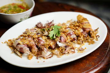 Squid Fried garlic and Seafood sauce in white dish