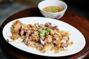 Squid Fried garlic and Seafood sauce in white dish