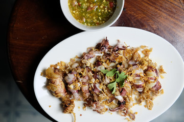 Squid Fried garlic and Seafood sauce in white dish