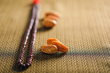 Date fruits with an Islamic prayer beads on an artistic background. Beautiful background for Ramzan or Ramadan. 