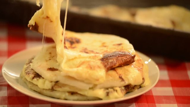 delicious video of Melted cheese pupusas steaming hot being cut open by hand in el salvador central america