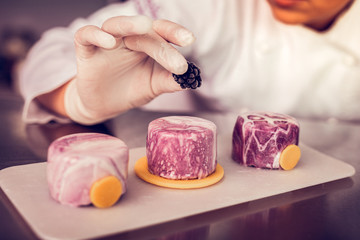 Close up of female hand that holding raspberry