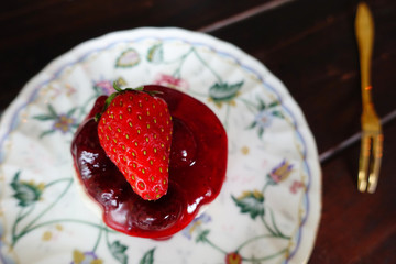 Strawberry jam with fresh berries on the plate