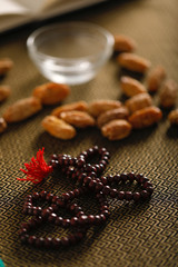 Dried dates in bowl. Dried Raw Organic Medjool date fruit and green mint in a  bowl on old wooden table close up.  