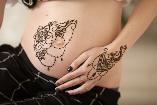 beautiful mehendi on pregnant, drawing on the belly henna, mandala