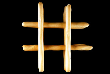 Small baguettes on a black isolated background.