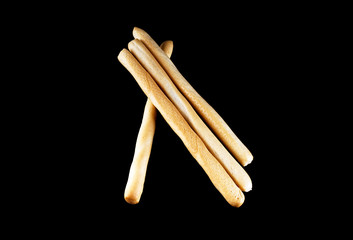 Small baguettes on a black isolated background.