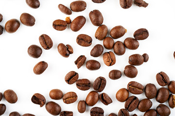 Scattered coffee beans on a white background.